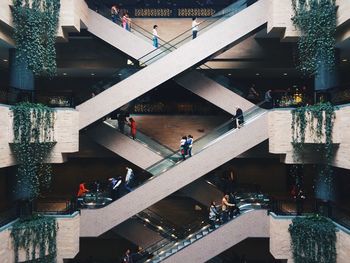 People on escalators in shopping mall