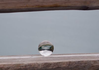 Close-up of crystal ball on wooden table