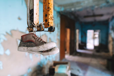 Close-up of padlocks hanging on rusty metal in abandoned school in chernobyl