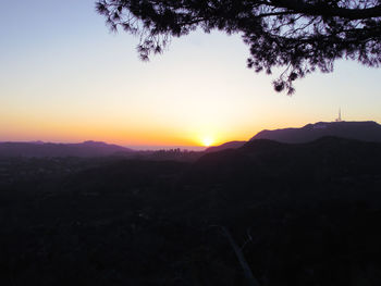 Scenic view of silhouette mountains against sky at sunset
