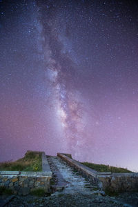 Surface level of pathway against starry sky