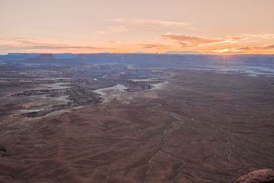 Aerial view of dramatic landscape against sky during sunset