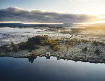 Snowy terrain and lake in autumn day