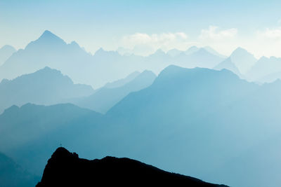 Scenic view of silhouette mountains against sky