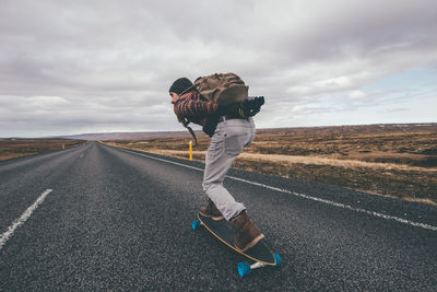 Man skateboarding on highway