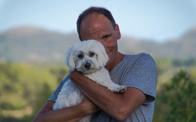 Portrait of smiling man with puppy