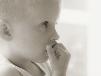 Side view of cute thoughtful boy looking away