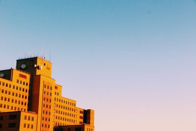 Low angle view of buildings against clear blue sky