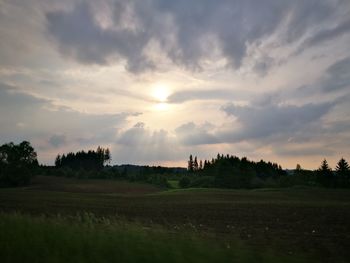 Scenic view of field against sky at sunset