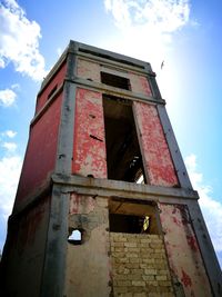 Low angle view of abandoned building against sky