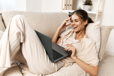 Young woman using laptop at home