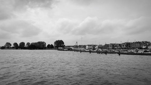 Panoramic shot of townscape by sea against sky