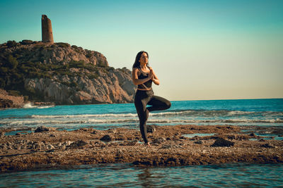 Full length of woman standing on beach