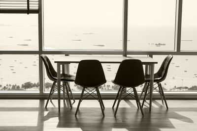 Empty chairs and table on tiled floor
