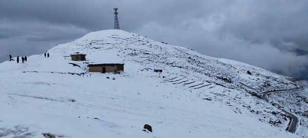 Scenic view of snow covered mountain against sky