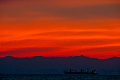 Scenic view of sea against orange sky