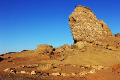 Sphinx rock formation against clear blue sky at bucegi natural park
