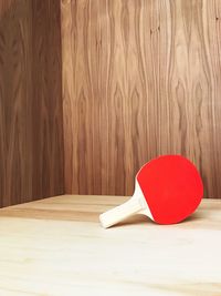 Close-up of table tennis racket on wood