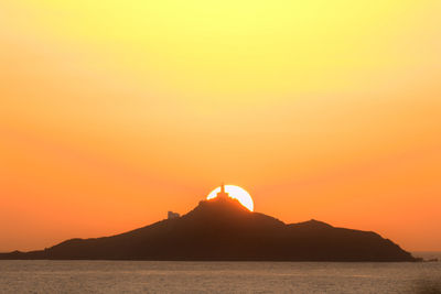 Scenic view of sea against orange sky