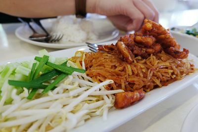 Cropped hand having meal at home