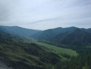 Scenic view of landscape and mountains against sky