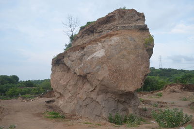 Rock formations on landscape against sky