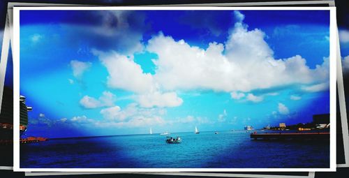 Boat in sea against cloudy sky