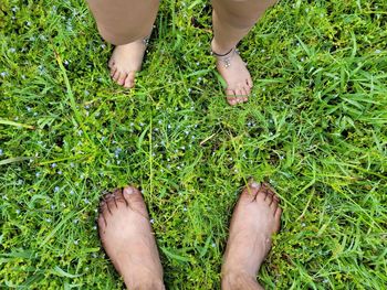 Low section of friends standing on field