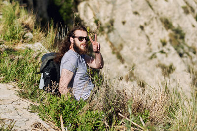 Young man wearing sunglasses walking outdoors