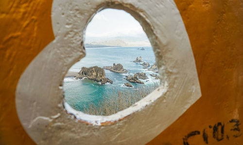 Close-up of sea seen through arch