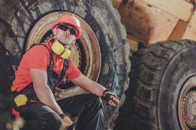 Midsection of man standing by car