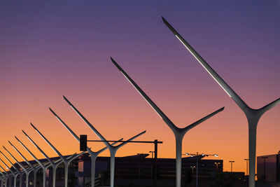 Low angle view of windmill against sky at sunset