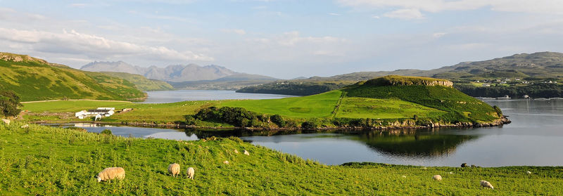 Scenic view of lake and mountains against sky