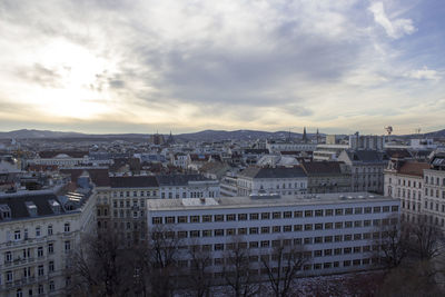 Cityscape against cloudy sky