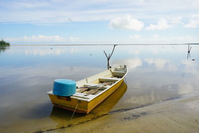 Ship moored on sea against sky
