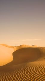 Scenic view of desert against sky during sunset