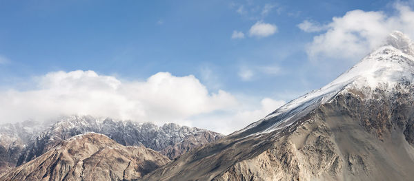 Panoramic view of snowcapped mountains against sky