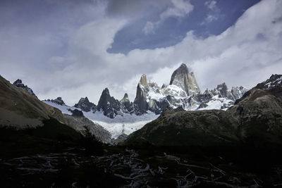 Scenic view of mountains against cloudy sky