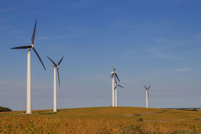 Windmill on field against sky