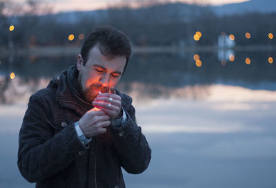 Close-up of young man lighting cigarette