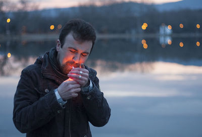 Close-up of young man lighting cigarette