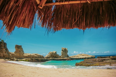 Scenic view of beach against blue sky