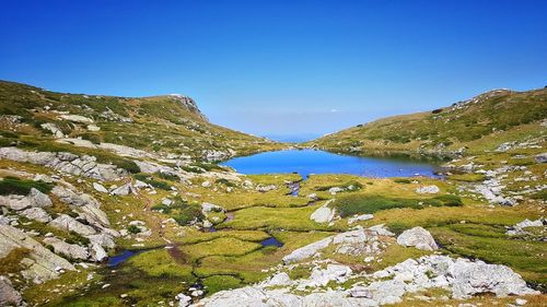 Scenic view of mountains against clear blue sky