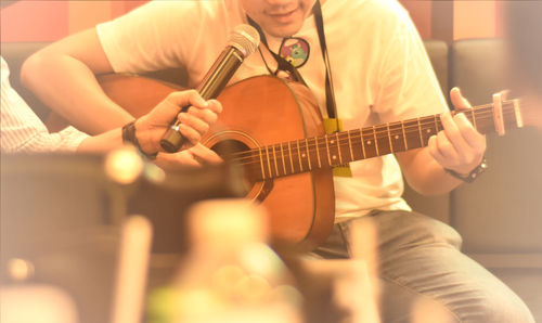 Music, men playing guitar in small party.