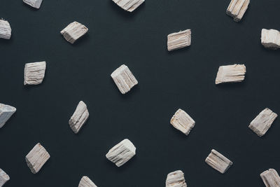 Full frame shot of wooden pieces on gray background