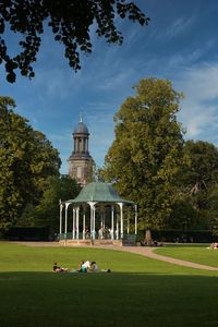 View of church building against cloudy sky with bandstand