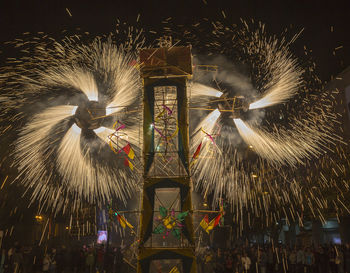 Low angle view of firework display at night