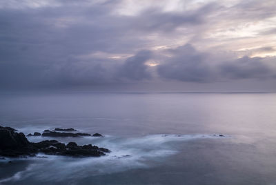 Scenic view of sea against cloudy sky