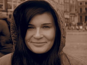 Close-up portrait of smiling woman in hood