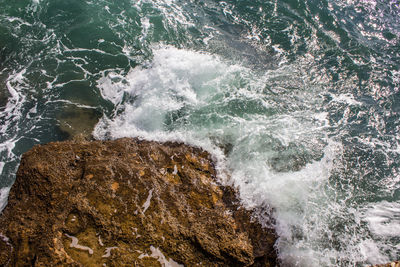 Waves splashing on rocky shore